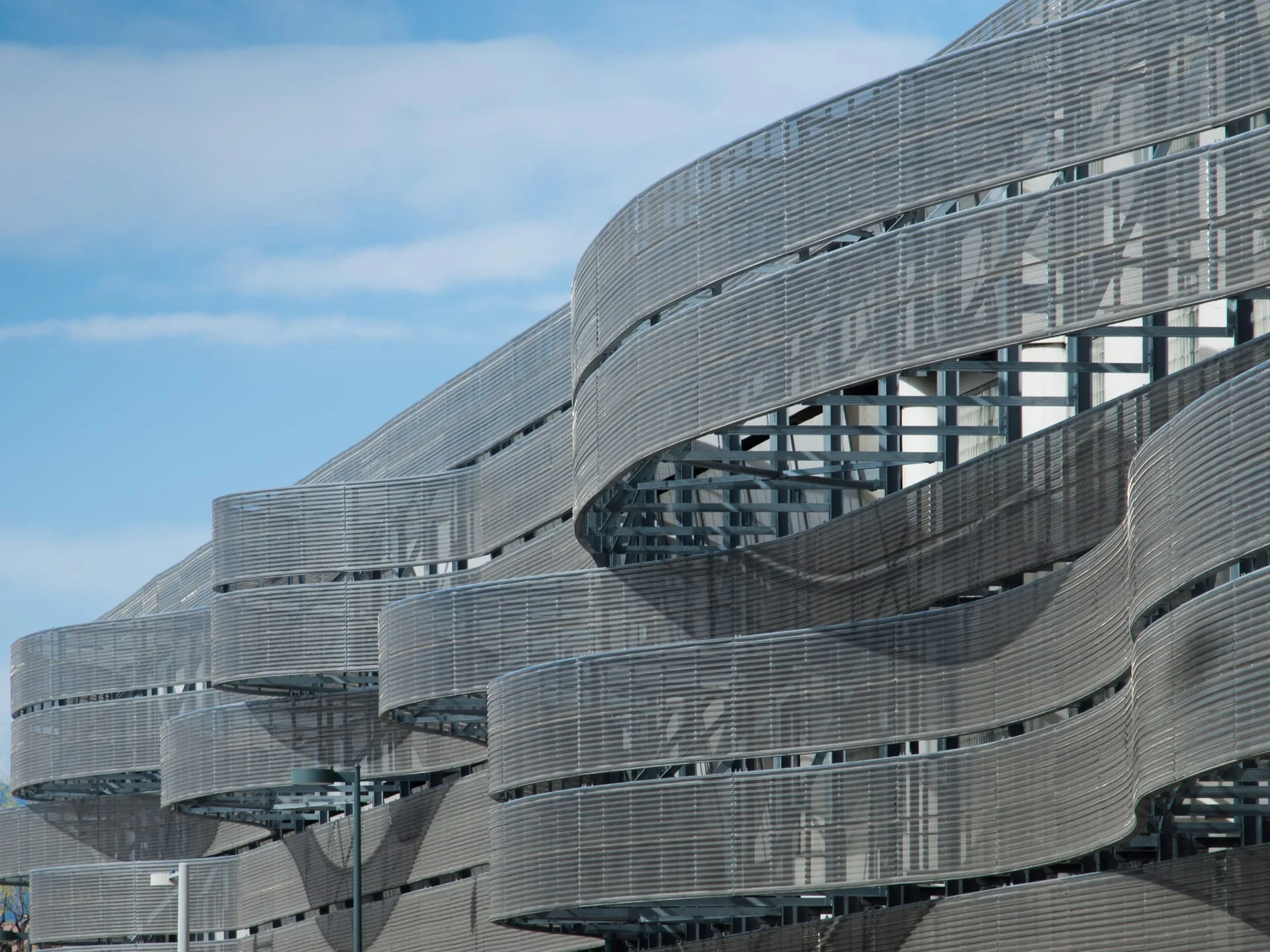 Curved woven wire mesh facade on a modern building